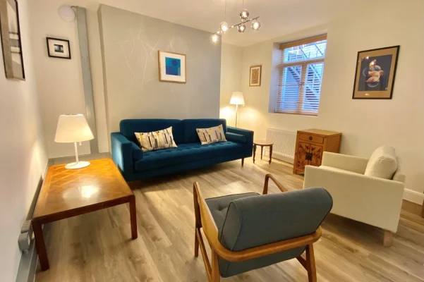 Private counselling room with sofa and chairs for in-person therapy sessions in King’s Cross